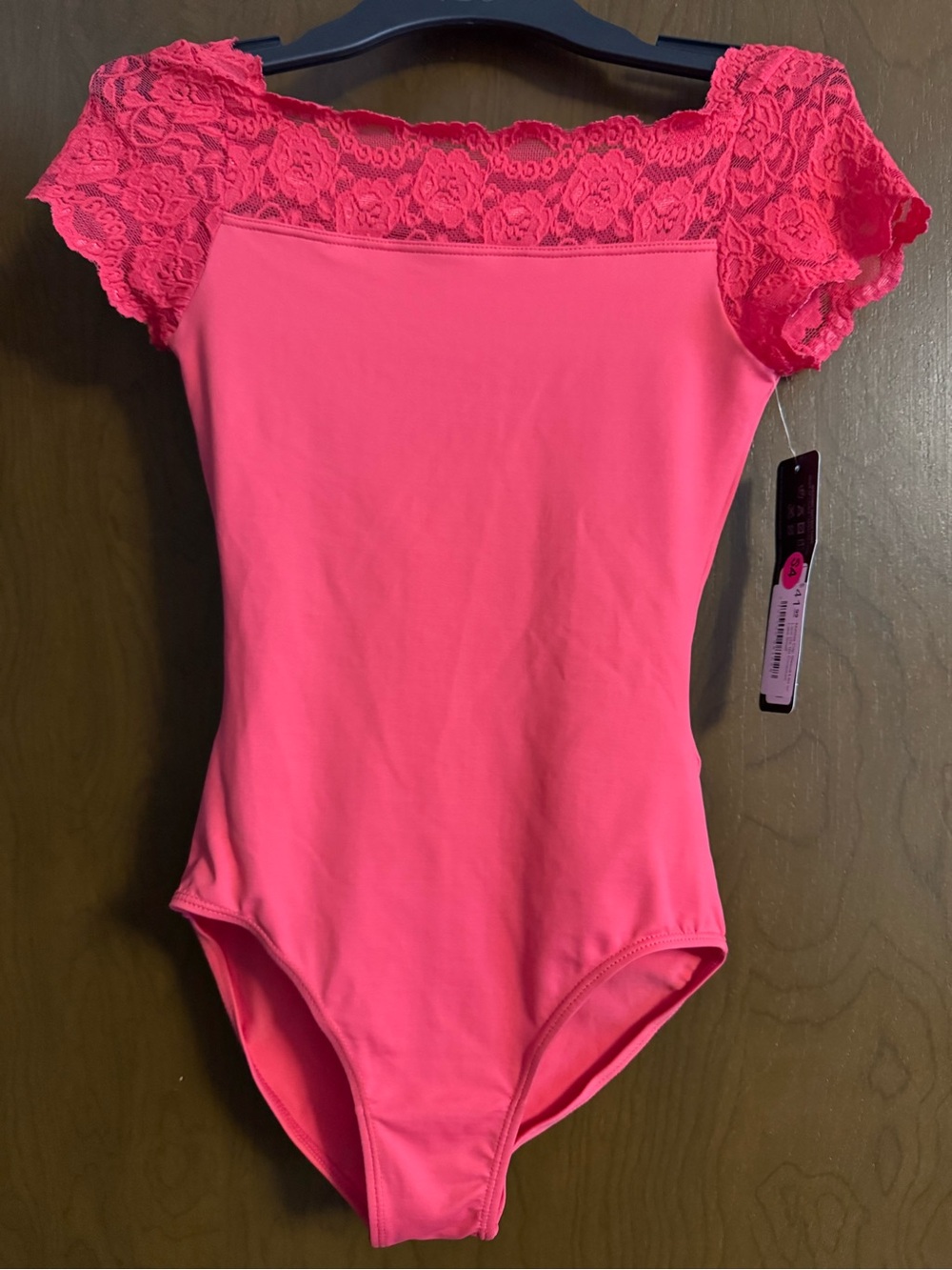 Lace-Trim Off-Shoulder Bodysuit in Bright dark peachy/ pink.